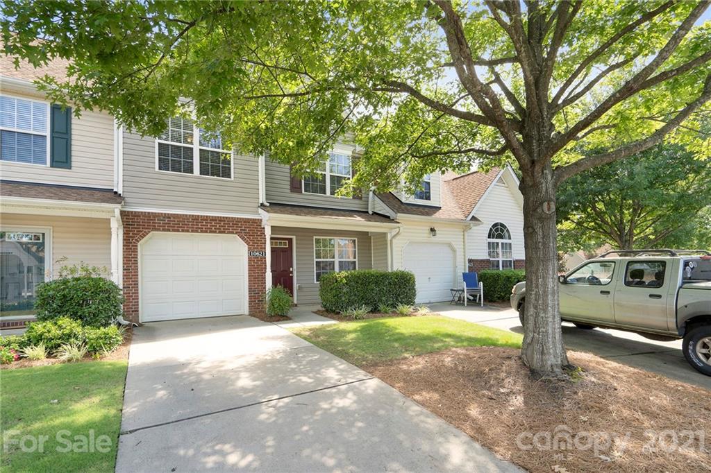 10621 Fuller Ridge Circle Charlotte, NC 28270 - Photo 28 of 32 a front view of a house with a yard and garage