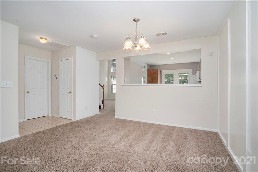 10621 Fuller Ridge Circle Charlotte, NC 28270 - Photo 6 of 32 a view of a big room with chandelier fan and windows