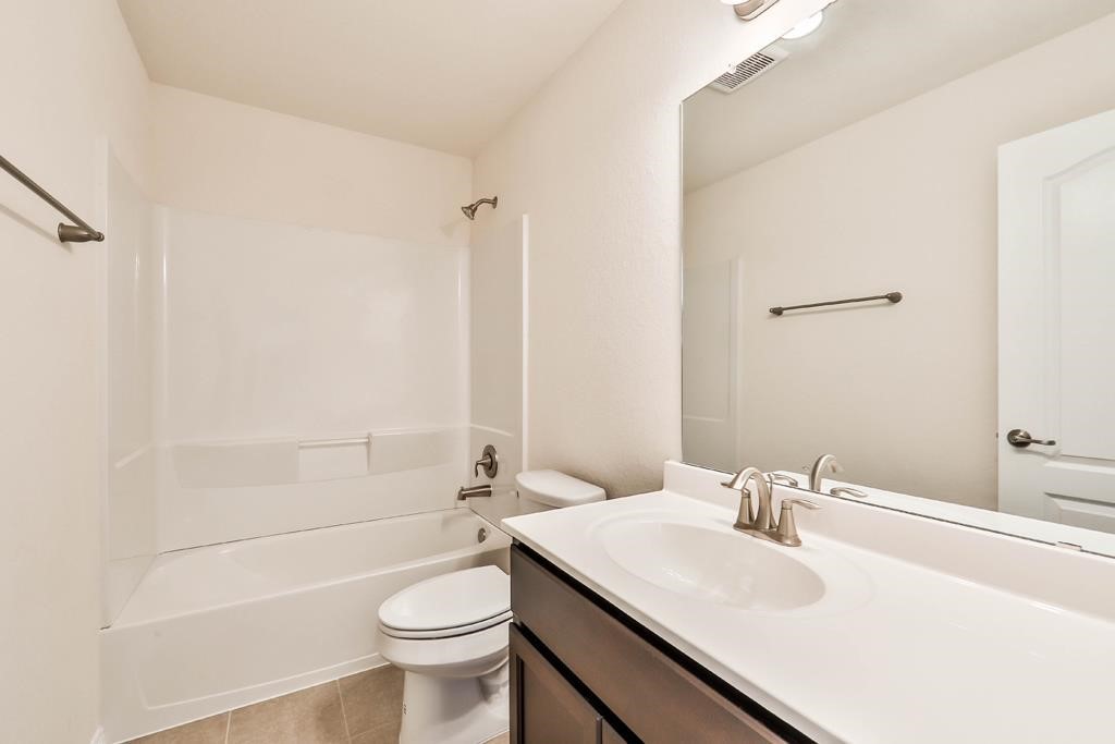 247 Sintra Lk Way Rosenberg, TX 77469 - Photo 23 of 28 a bathroom with a sink a toilet and shower