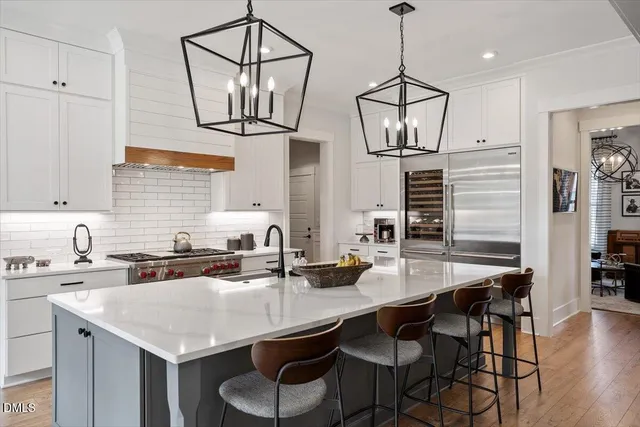 a kitchen with a table a sink and cabinets