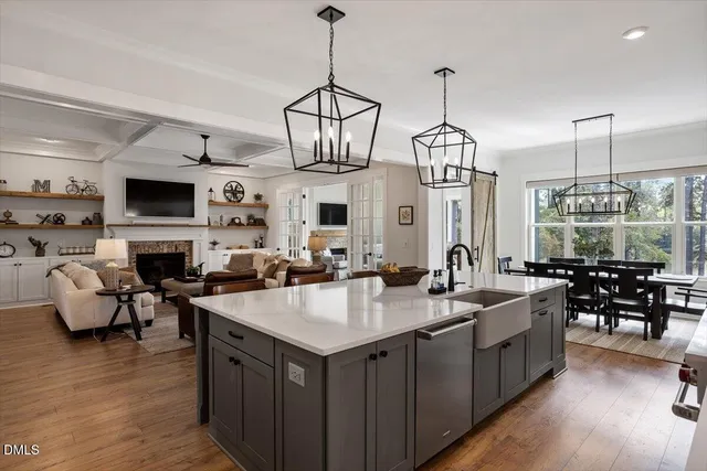 a kitchen with sink a center island and living room view