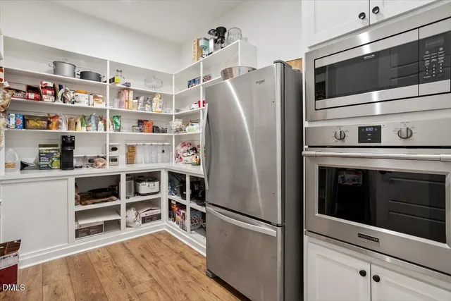a kitchen with stainless steel appliances and cabinets