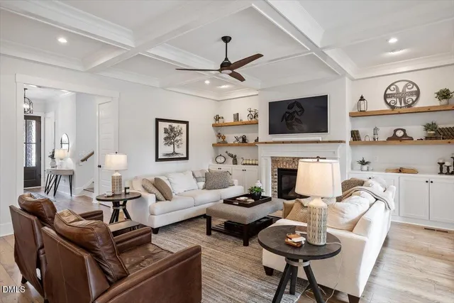 a living room with furniture a flat screen tv and a fireplace