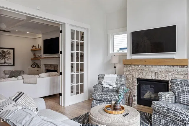 a living room with furniture a flat screen tv and a fireplace