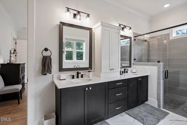 a bathroom with a double vanity sink a toilet and mirror