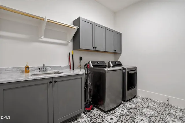 a utility room with sink dryer and washer