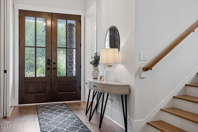 a view of entryway with wooden floor and stair