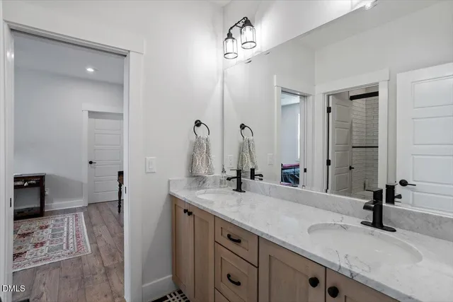 a bathroom with a double vanity sink and a mirror