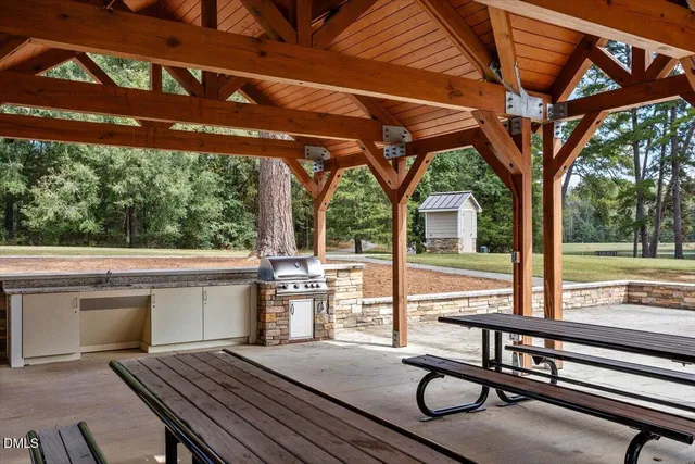 a view of backyard with deck and outdoor seating