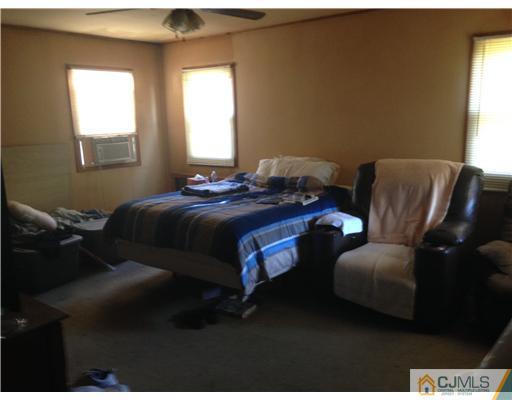 210 Morganville Road Old Bridge, NJ 07747 - Photo 3 of 8 a bed room with a bed and a couch