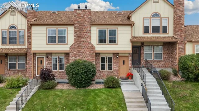 a front view of a house with a yard outdoor seating and garage