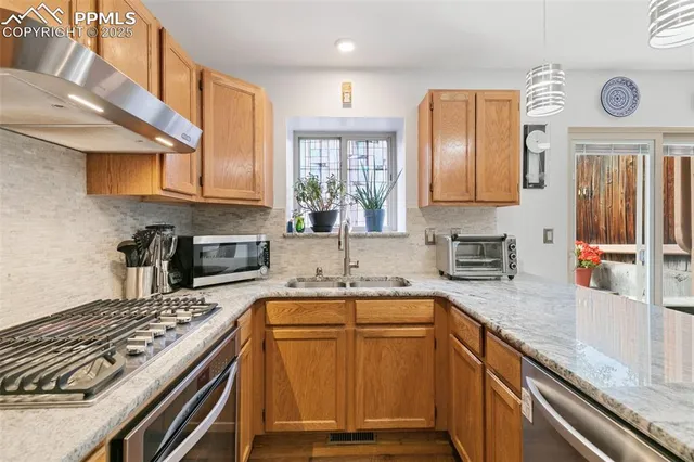 a kitchen with a sink stove top oven and cabinets