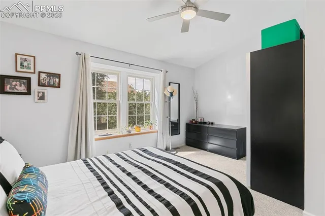 a bedroom with a bed and a large window