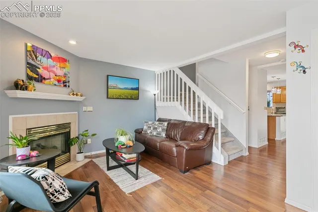 a living room with furniture wall paintings and a fireplace