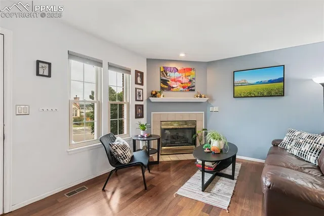 a living room with furniture a fireplace and a flat screen tv