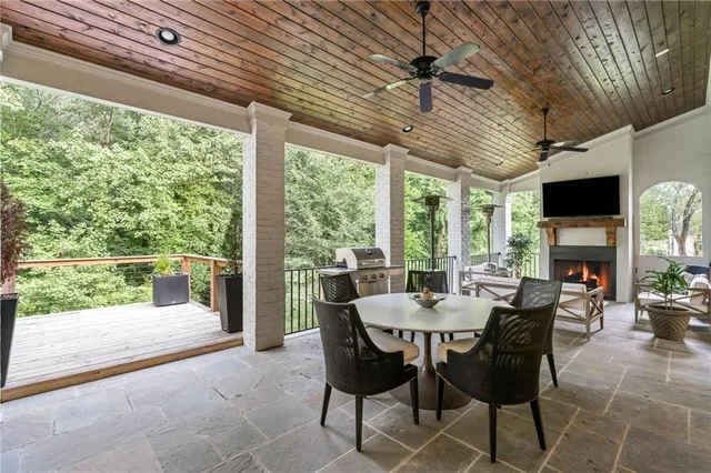 a living room with furniture a fireplace and a floor to ceiling window