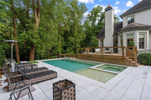 a large kitchen with stainless steel appliances granite countertop a large counter top a stove and a refrigerator