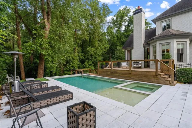 a large kitchen with stainless steel appliances granite countertop a large counter top a stove and a refrigerator