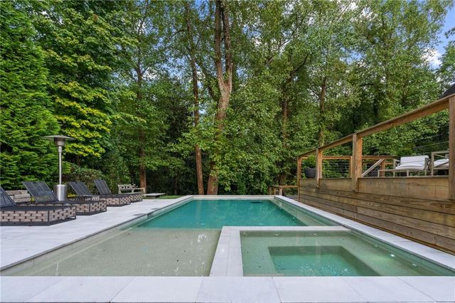 a spacious en suite bathroom with a large window and a bathtub