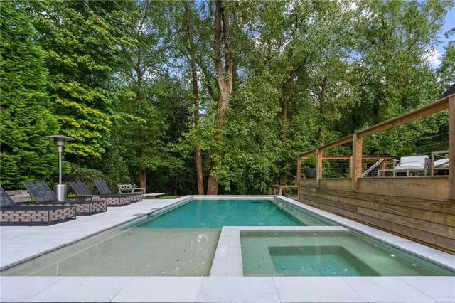 a spacious en suite bathroom with a large window and a bathtub
