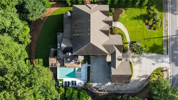an aerial view of a house with a swimming pool patio and outdoor seating