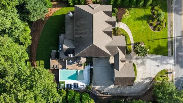 an aerial view of a house with a swimming pool patio and outdoor seating