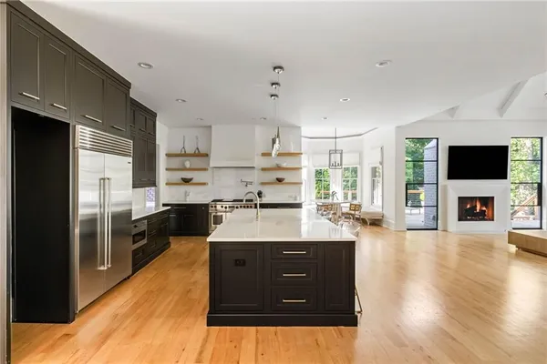 a spacious bedroom with a bed and a flat screen tv