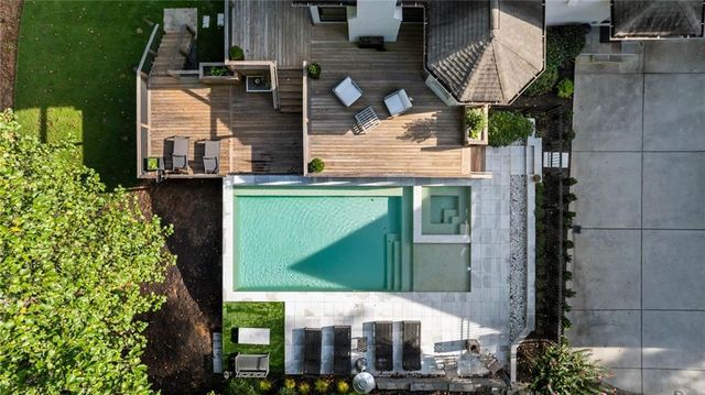 a living room with furniture a fireplace and a large window