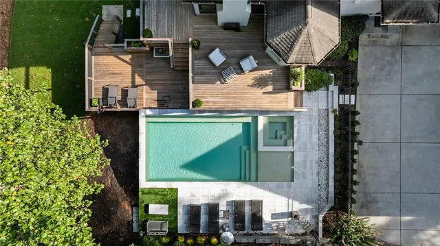 a living room with furniture a fireplace and a large window