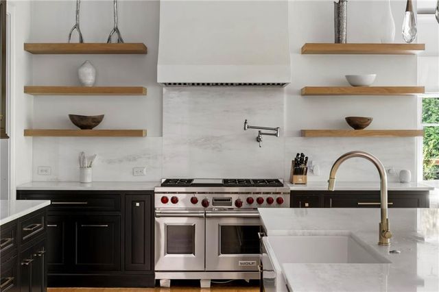 a spacious bathroom with a granite countertop sink mirror and a