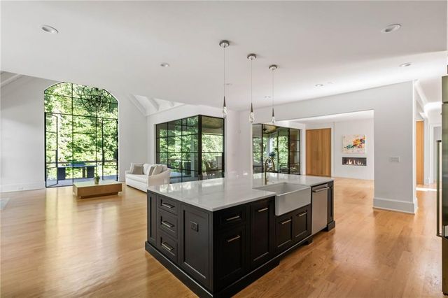 a kitchen with stainless steel appliances granite countertop a sink and cabinets