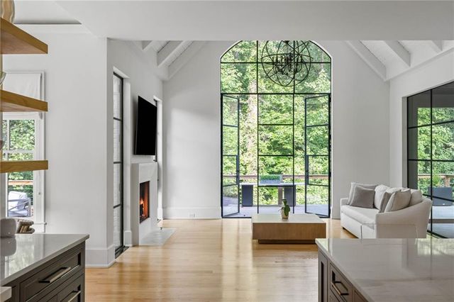 a spacious bedroom with two beds and a chandelier