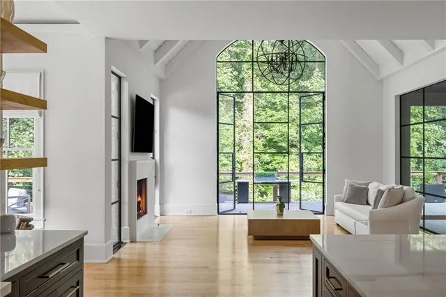a spacious bedroom with two beds and a chandelier
