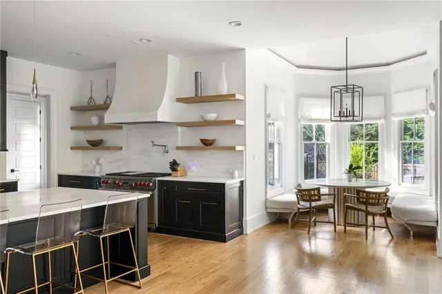 a bathroom with a granite countertop sink a toilet and a mirror