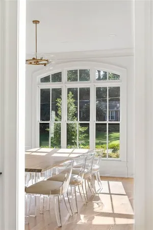 a spacious bedroom with a bed and a flat tv screen on a table