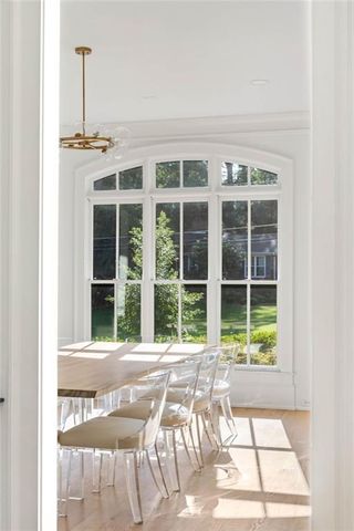 a spacious bedroom with a bed and a flat tv screen on a table