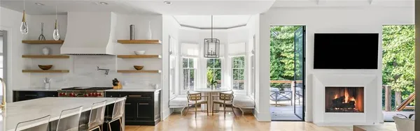 a view of a hallway with wooden floor and a living room