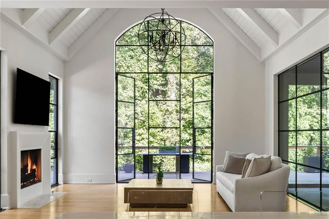 a view of a living room with furniture and floor to ceiling window