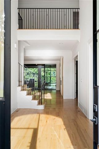 a living room with furniture a fireplace and a floor to ceiling window