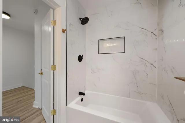 a bathroom with a bathtub and shower