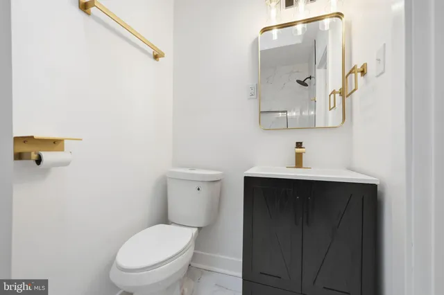 a bathroom with a toilet sink and mirror