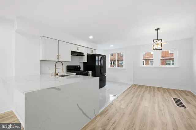 a view of kitchen with refrigerator and window