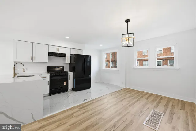 a kitchen with granite countertop a refrigerator and a sink
