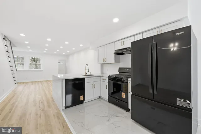 a kitchen with a refrigerator and a stove top oven