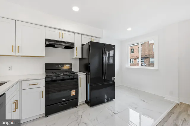 a kitchen with stainless steel appliances a refrigerator stove and sink