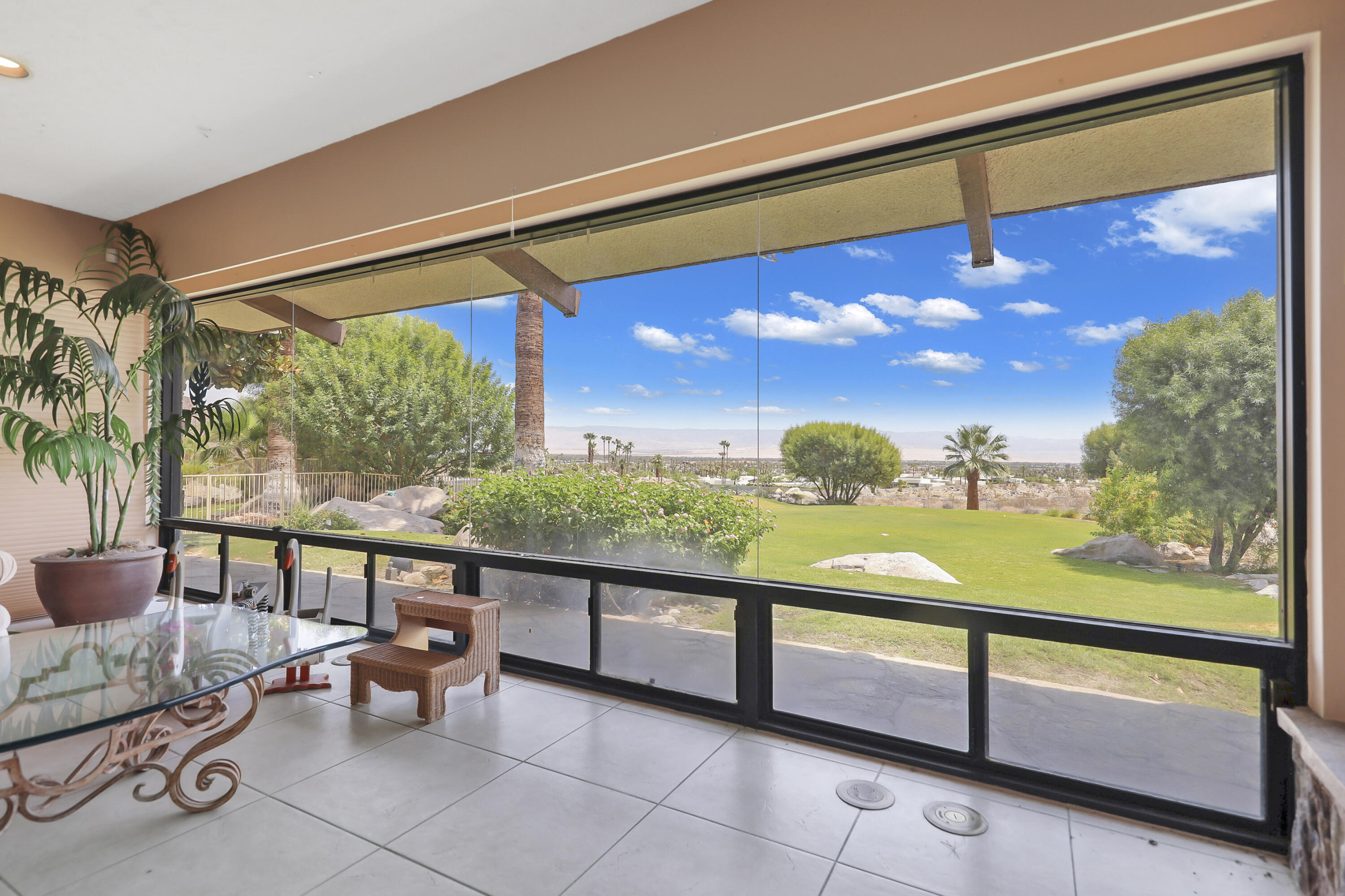 770 South La Mirada Road Palm Springs, CA 92264 - Photo 22 of 39 a view of a porch with furniture and a yard