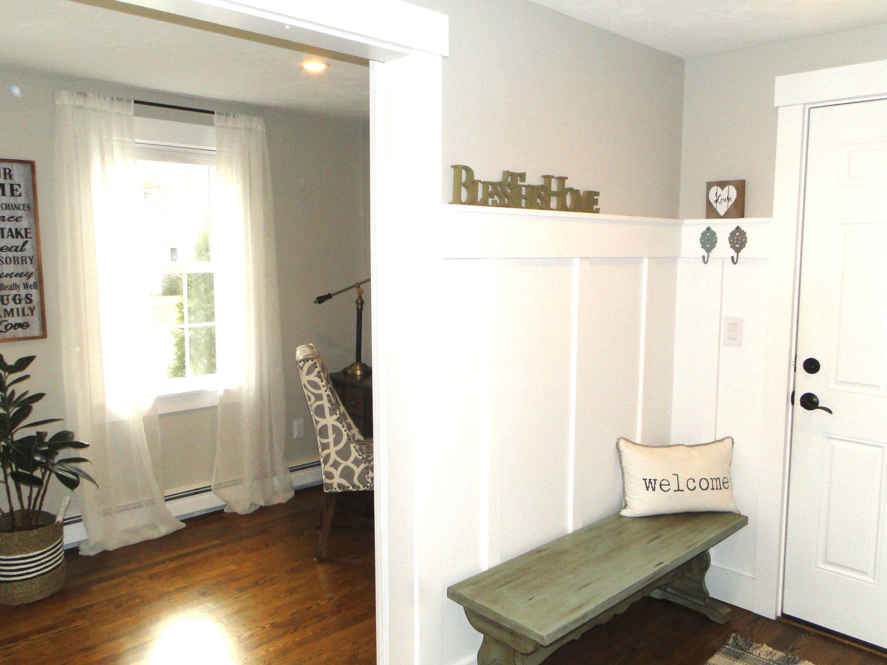 30 Brewster Road Mashpee, MA 02649 - Photo 12 of 58 a view of a hallway with wooden floor and a living room