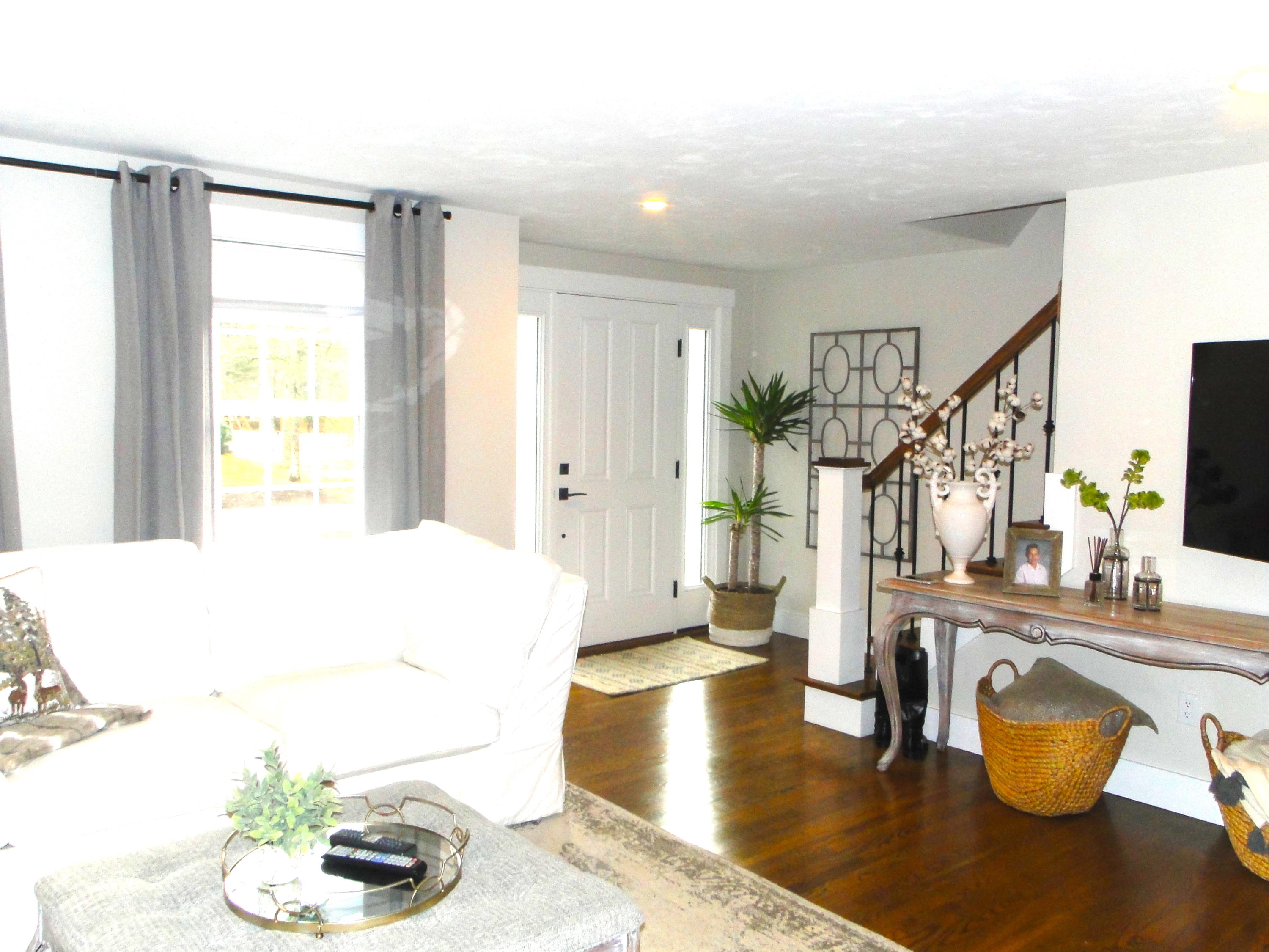 30 Brewster Road Mashpee, MA 02649 - Photo 19 of 58 a living room with dining table and a wooden floor