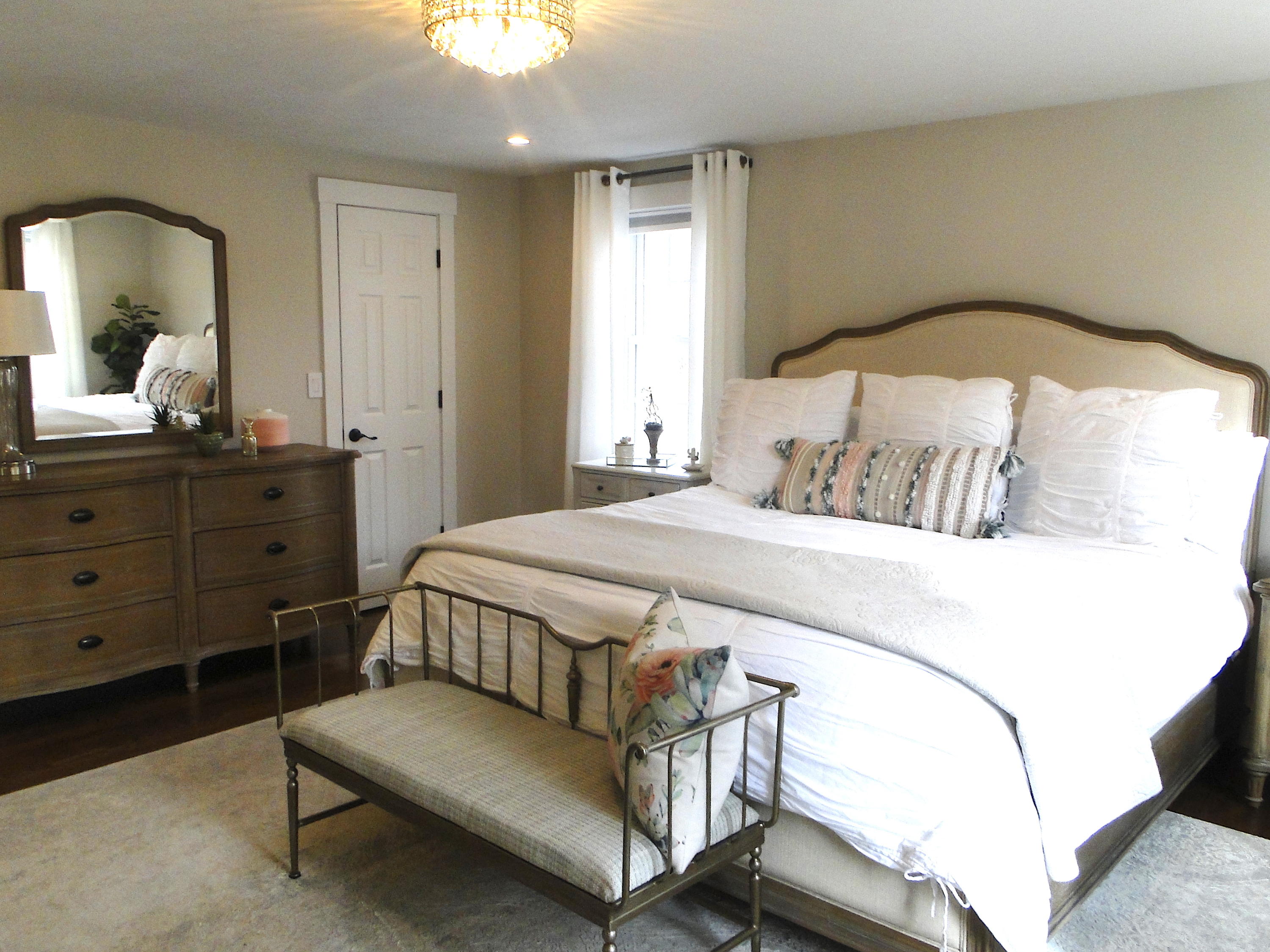 30 Brewster Road Mashpee, MA 02649 - Photo 36 of 58 a bedroom with a bed table and a mirror