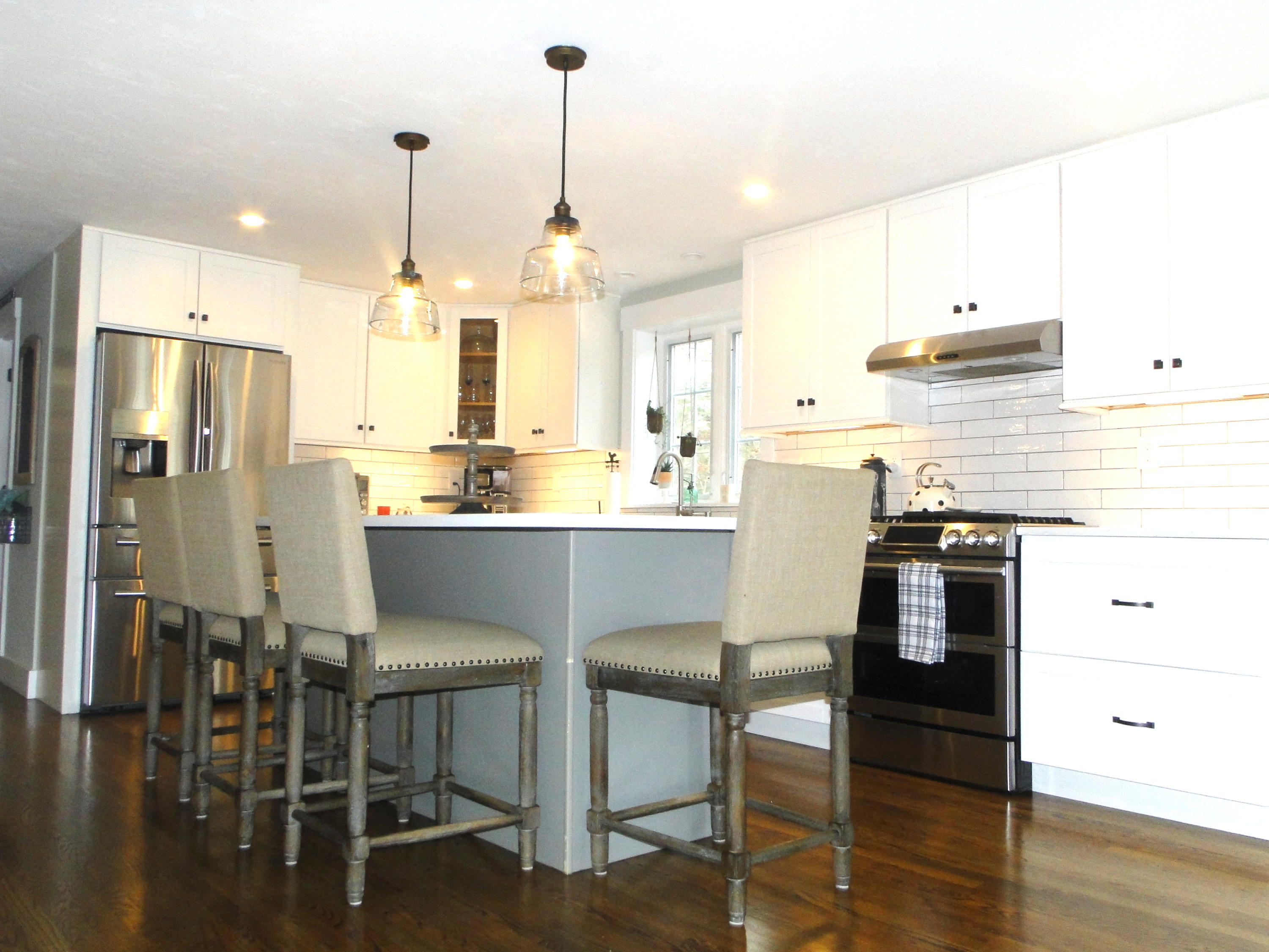 30 Brewster Road Mashpee, MA 02649 - Photo 4 of 58 a kitchen with stainless steel appliances kitchen island a table chairs and a refrigerator